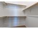 A clean, well-organized walk-in closet with wooden rods and shelves at 3684 Mooncrest Cir, Las Vegas, NV 89129