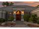 Charming single-story home featuring a tiled roof, arched entryway, and beautiful landscaping at 3684 Mooncrest Cir, Las Vegas, NV 89129