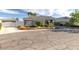 Charming single-story home featuring a detached garage and a well-manicured front yard with mature landscaping at 3684 Mooncrest Cir, Las Vegas, NV 89129