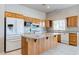 Spacious kitchen features custom wood cabinetry, granite countertops, and a large center island at 3684 Mooncrest Cir, Las Vegas, NV 89129
