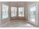 Bright kitchen nook with large windows offering views of the landscaped backyard, and a glass paneled door at 3684 Mooncrest Cir, Las Vegas, NV 89129