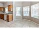 Bright kitchen nook with large windows offering a view of the backyard, and the in-ground pool at 3684 Mooncrest Cir, Las Vegas, NV 89129