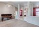 Spacious living room featuring an upright piano, carpeted floors, and decorative columns at 3684 Mooncrest Cir, Las Vegas, NV 89129