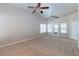 Large living room with carpet flooring, two ceiling fans and natural light at 3684 Mooncrest Cir, Las Vegas, NV 89129