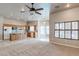 Open concept living area with a kitchen island, wood cabinets, and ample natural light, creating an inviting space at 3684 Mooncrest Cir, Las Vegas, NV 89129