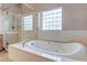 Relax in this large soaking tub with a glass block window and separate walk-in shower at 3684 Mooncrest Cir, Las Vegas, NV 89129