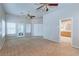 Large primary suite with double doors to bathroom and rear patio access through glass doors at 3684 Mooncrest Cir, Las Vegas, NV 89129