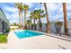 Inviting pool area surrounded by swaying palm trees and a well-manicured backyard offers a private oasis at 3684 Mooncrest Cir, Las Vegas, NV 89129
