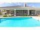 Backyard pool with covered patio and tile roof of home in a private backyard at 3684 Mooncrest Cir, Las Vegas, NV 89129