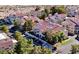 Aerial view showcases the community's layout, parking, and lush green trees at 3740 Desert Marina Dr # 12, Laughlin, NV 89029