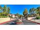 Inviting gated community entrance with lush landscaping and manicured flowerbeds at 3740 Desert Marina Dr # 12, Laughlin, NV 89029
