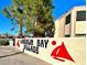 Laughlin Bay Village community sign with mature trees and clear blue sky in the background at 3740 Desert Marina Dr # 12, Laughlin, NV 89029