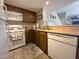 Efficient kitchen boasts ample wood cabinets, white appliances, and a practical layout at 3740 Desert Marina Dr # 12, Laughlin, NV 89029