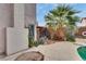 This backyard features a mature palm tree, concrete patio, pool and access to a covered area at 3886 Green Leaf Dr, Las Vegas, NV 89120