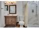 Updated bathroom showcasing a vanity with cabinets, a toilet, and a shower featuring white marble-patterned walls at 3886 Green Leaf Dr, Las Vegas, NV 89120