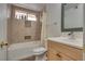 Cozy bathroom featuring a bathtub with shower, vanity, and toilet, all bathed in natural light from the window at 3886 Green Leaf Dr, Las Vegas, NV 89120