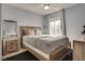 Comfortable bedroom with ample light from a window next to a bed, nightstand, dresser, and mirror at 3886 Green Leaf Dr, Las Vegas, NV 89120