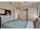 Cozy bedroom featuring a ceiling fan, TV, and closet at 3886 Green Leaf Dr, Las Vegas, NV 89120