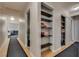 A well-lit hallway with hardwood floors and built-in storage spaces, showcasing a functional and stylish design at 3886 Green Leaf Dr, Las Vegas, NV 89120