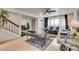 Cozy living room with hardwood floors, a staircase, and views into the dining area at 3886 Green Leaf Dr, Las Vegas, NV 89120