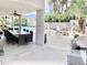 Covered outdoor dining area with a large table, alongside a relaxing outdoor lounge with a firepit near the pool at 3886 Green Leaf Dr, Las Vegas, NV 89120