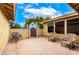 Backyard patio area featuring comfortable chairs and a brick fence, perfect for outdoor relaxation at 3905 Cherokee Ave, Las Vegas, NV 89121