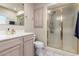 Bathroom featuring a vanity with ample storage, a mirror, and a glass-enclosed shower at 3905 Cherokee Ave, Las Vegas, NV 89121