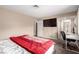 Inviting bedroom with a mounted TV, desk, and ensuite bathroom with a glass-door shower at 3905 Cherokee Ave, Las Vegas, NV 89121