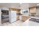Well-lit kitchen with ample cabinet space, a white refrigerator, and modern appliances at 3905 Cherokee Ave, Las Vegas, NV 89121