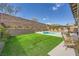 Backyard showcasing a lawn and luxurious pool, perfect for outdoor enjoyment and relaxation at 421 Malpaso St, Las Vegas, NV 89138