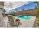 Backyard featuring a pool, outdoor dining set, and a built-in grill perfect for entertaining at 421 Malpaso St, Las Vegas, NV 89138