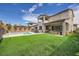 A beautifully landscaped backyard with a pristine pool, barbecue area, and covered patio for outdoor enjoyment at 421 Malpaso St, Las Vegas, NV 89138