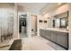 Spacious bathroom featuring a walk-in closet, tile flooring, and double vanity sinks at 421 Malpaso St, Las Vegas, NV 89138