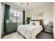 Cozy bedroom featuring a large window, dresser, and comfortable bed at 421 Malpaso St, Las Vegas, NV 89138