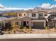 Charming two-story home with a well-manicured front yard, attached garage, and mountain views at 421 Malpaso St, Las Vegas, NV 89138