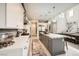 Spacious kitchen with gray island, white perimeter cabinets, stainless appliances, and direct access to living area at 421 Malpaso St, Las Vegas, NV 89138