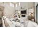 Cozy living room with fireplace, plush sectional sofa, and plenty of natural light from large windows at 421 Malpaso St, Las Vegas, NV 89138