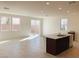 Spacious kitchen featuring a large island, tile floors, white walls and granite countertops at 4274 Tarim St, Las Vegas, NV 89147