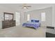 Bright bedroom with a ceiling fan, dresser, and a comfortable bed with blue floral bedding at 4436 Mural Glen Ct, North Las Vegas, NV 89084
