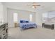 Large bedroom with a ceiling fan, two windows, and two dressers at 4436 Mural Glen Ct, North Las Vegas, NV 89084