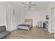 Bright bedroom featuring wood floors, a ceiling fan, curtains, and contemporary decor at 4436 Mural Glen Ct, North Las Vegas, NV 89084