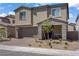 Charming two-story home with a stone-accented front porch and well-maintained landscaping at 4436 Mural Glen Ct, North Las Vegas, NV 89084