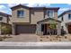 Charming two-story home with a stone-accented front porch and well-maintained landscaping at 4436 Mural Glen Ct, North Las Vegas, NV 89084