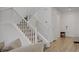 Open foyer with staircase, light wood floors, and natural light from the doorway at 4436 Mural Glen Ct, North Las Vegas, NV 89084