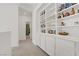 Well-lit hallway with custom built-in display and storage cabinets at 4436 Mural Glen Ct, North Las Vegas, NV 89084