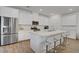 Spacious eat-in kitchen features stainless appliances, a large quartz island with seating and wood-style flooring at 4436 Mural Glen Ct, North Las Vegas, NV 89084