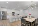 Open kitchen with island, stainless steel appliances, bar seating and dining area at 4436 Mural Glen Ct, North Las Vegas, NV 89084