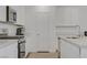 Bright kitchen features stainless steel appliances and white cabinets at 4436 Mural Glen Ct, North Las Vegas, NV 89084