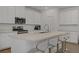 Kitchen featuring quartz counters, island with bar seating and white cabinets at 4436 Mural Glen Ct, North Las Vegas, NV 89084