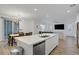 Open concept kitchen with an island that flows into the dining and living areas at 4436 Mural Glen Ct, North Las Vegas, NV 89084